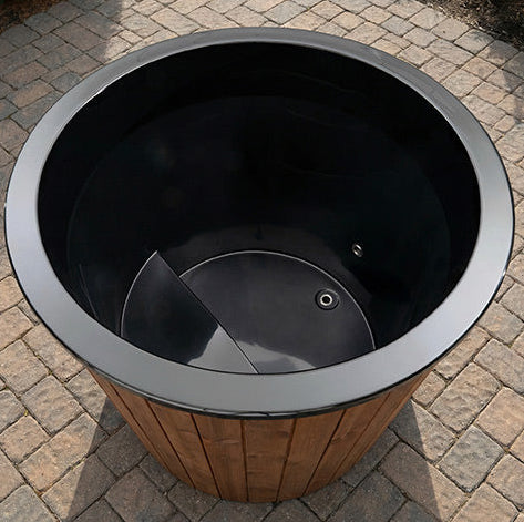 Black trash bin with wooden base on a paved surface