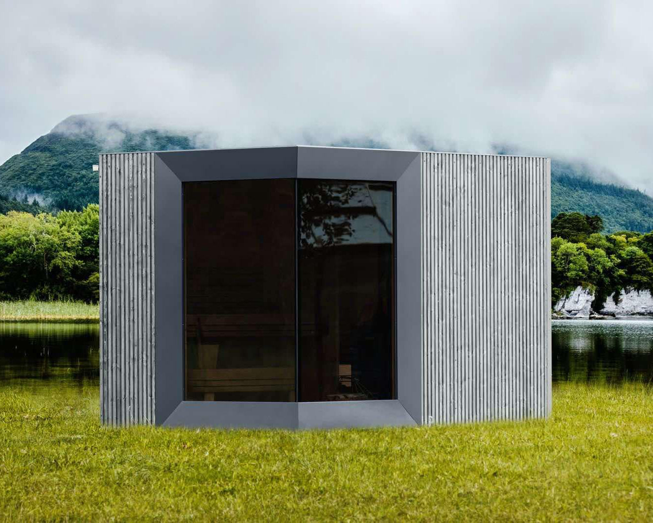 Modern outdoor cabin with a scenic mountain and lake background