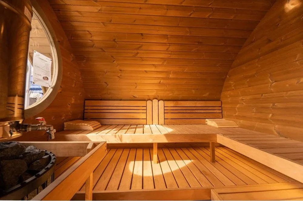 Wooden sauna interior with benches and a small window.