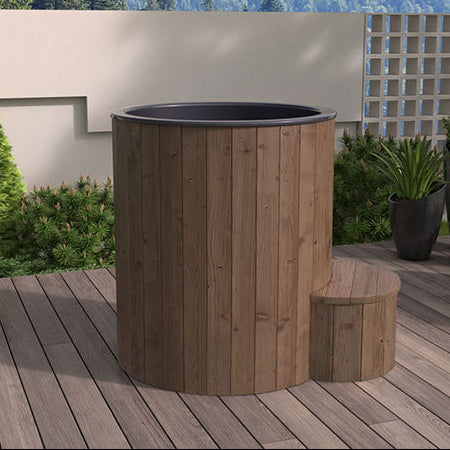 Wooden hot tub on a wooden deck with a scenic background