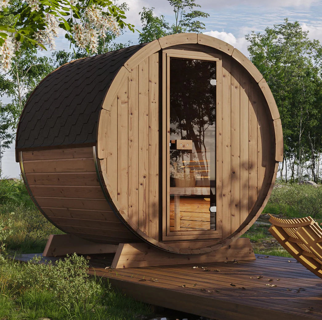 Wooden barrel-shaped structure in a natural setting with greenery and a clear sky.